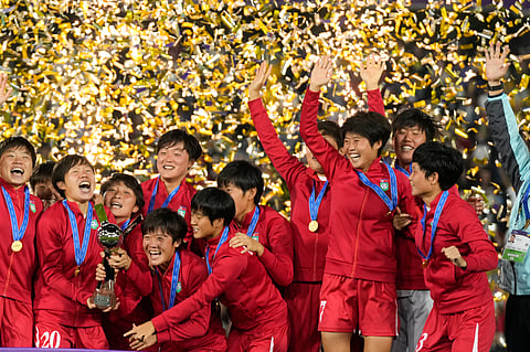 North Korean players celebrate with the trophy after winning the U-20 Women's World Cup final soccer match against Japan at El Campin stadium in Bogota, Colombia on Sunday.