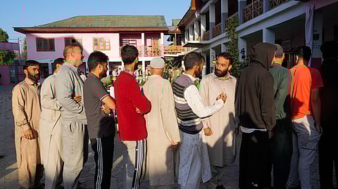 People wait in a queue to cast their votes during the third and final phase of Jammu & Kashmir Assembly elections, at Handwara in Kupwara district of North Kashmir.