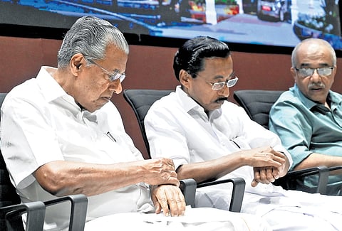 Chief Minister Pinarayi Vijayan and Kozhikode CPM district secretary P Mohanan check the time on their wristwatches during the inaugural function of AKG Auditorium in Kozhikode