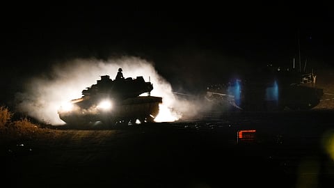 An Israeli mobile artillery unit fires a shell from northern Israel towards Lebanon, in a position near the Israel-Lebanon border.