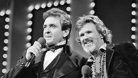 Country stars Johnny Cash, left, and Kris Kristofferson sing during the Country Music Awards in Nashville, Tenn., Oct 1983.