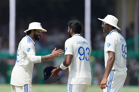India's Jasprit Bumrah, centre, Ravindra Jadeja, left and Ravichandran Ashwin celebrates the wicket of Bangladesh's Mushfiqur Rahim.