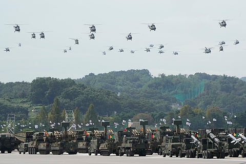 South Korean military helicopters fly over armored vehicles during the media day for the 76th anniversary of Armed Forces Day at Seoul air base in Seongnam, South Korea, Wednesday, Sept. 25, 2024.
