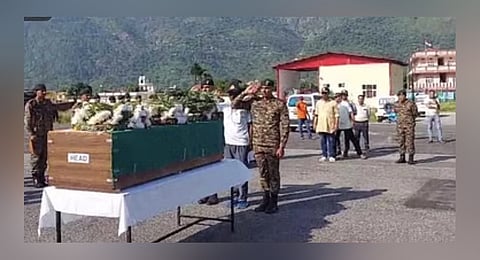 Tribute to a Hero: Armed forces personel salute martyr Narain Singh upon his arrival at Gauchar helipad in Chamoli, Uttarakhand.