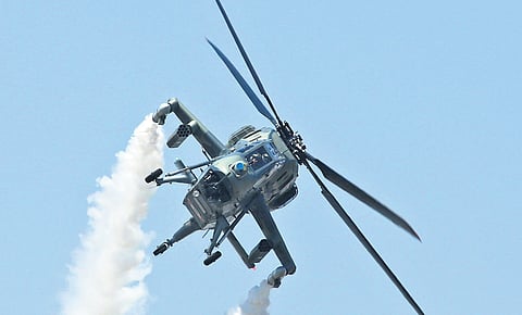A helicopter manoeuvres during the 14th edition of Aero India 2023