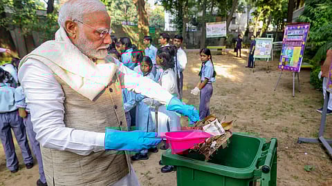 Prime Minister Narendra Modi takes part in a cleanliness drive at a school on the ocassion of Gandhi Jayanti, in New Delhi, Wednesday.
