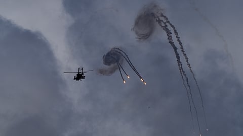 An Israeli Apache helicopter releases flares near the Israeli-Lebanon border, as seen from northern Israel, Wednesday.