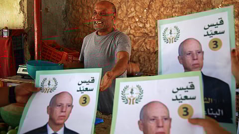 Supporters of Tunisian President and candidate for re-election Kais Saied meet with residents of a neighbourhood during a campaign tour, in Ariana, Tunisia, Thursday, Sept. 26, 2024.