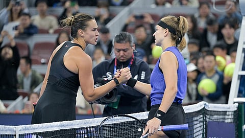 Czech Republic’s Karolina Muchova (R) shakes hands after winning against Belarus's Aryna Sabalenka in their women's singles quarterfinal match at the China Open in Beijing