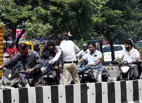 Image of helmetless motorists used for representative purpose