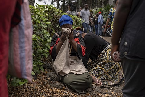 Women grieve at the port of Goma, Democratic Republic of Congo, after a ferry carrying hundreds capsized on arrival, Thursday, Oct 3, 2024.