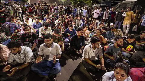 Junior doctors stage a sit-in protest on a road in Kolkata