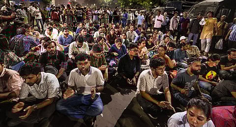 Junior doctors stage a sit-in protest on a road in Esplanade area over the alleged police lathi-charge against a few of them during a rally to press for justice for the deceased woman doctor of RG Kar hospital, in Kolkata, Friday, Oct 4, 2024.