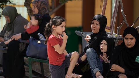 Displaced people sit at a vocational training center run by the U.N. agency for Palestinian refugees, or UNRWA, in the southern town of Sebline, south of Beirut, Lebanon, Friday, Oct. 4, 2024, after fleeing the Israeli airstrikes in the south.