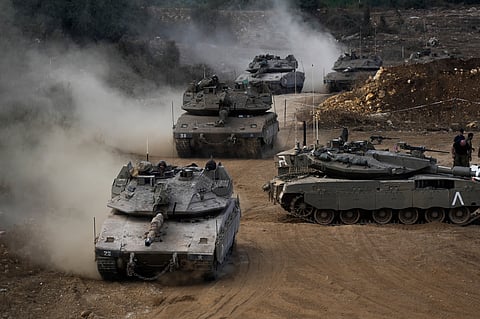 Israeli army tanks manoeuvre in a staging area in northern Israel near the Israel-Lebanon border, Tuesday, Oct. 1, 2024.