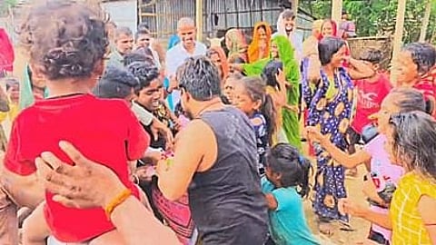 Flood victims reaching out for relief materials.