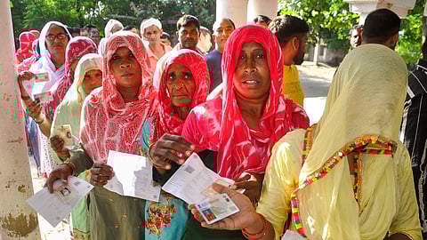 Women wait in a queue to cast their votes at a polling station during the Haryana Assembly elections, in Sonipat, Saturday, Oct. 5, 2024