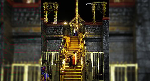 A father-son duo climbing the holy steps of Sabarimala. There was a steep decline in arrival of devotees at Sabarimala.