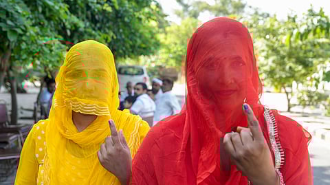 Voters show their inked fingers after casting votes during the Haryana Assembly elections, at Badsa village in Badli tehsil of Jhajjar district, Haryana.
