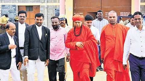 Shivamurthy Murugha Sharana walks out of the court in Chitradurga