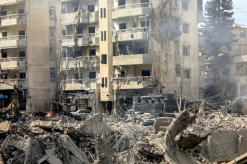 This picture shows a view of a crater where a collapsed building stood following an overnight Israeli air strike on the neighbourhood of Kafaat in Beirut's southern suburbs, on October 7, 2024.