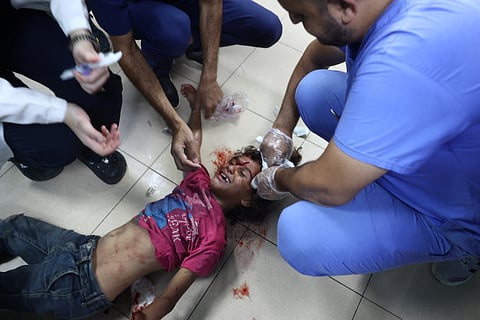 Palestinian medics treat a girl who was injured in Israeli strikes on a displacement camp in the Bureij refugee camp, at the al-Aqsa Martyrs hospital in Deir al-Balah in the central Gaza Strip on October 8, 2024.