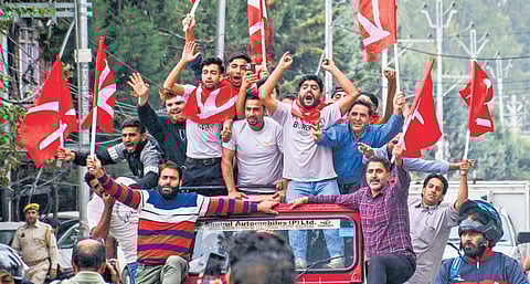 National Conference supporters celebrate as the party leads during the counting of votes in Srinagar on Tuesday.