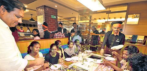 Slum children enjoying lunch at Barbeque Nation on Tuesday
