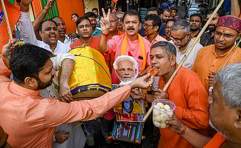 BJP workers celebrate the party's lead during the counting of votes of Haryana Assembly elections, at party office in Kolkata, Tuesday, Oct. 8, 2024.