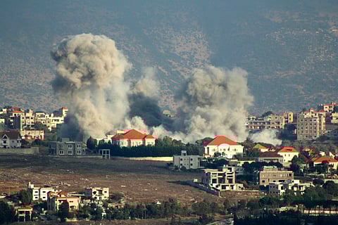 A plume of smoke billows following an Israeli air strike on the village of Khiam in southern Lebanon near the border with Israel on October 7, 2024.
