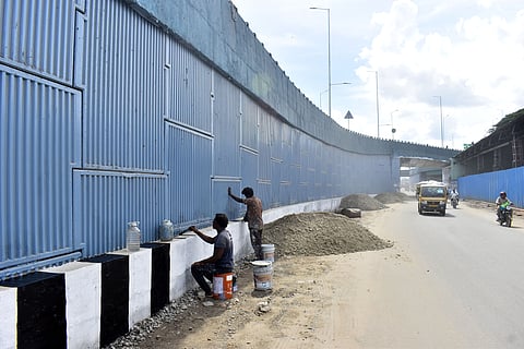 Workers engaged in pending works of Sungam Ramp of the Ukkadam Flyover in Coimbatore on Tuesday.
