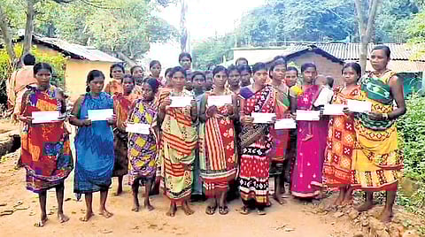 The victims of Banuaguda village holding their loan letters