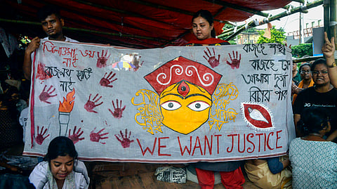 People hold a banner during the Junior Doctors fast-unto-death hunger strike demanding justice for the victim of the RG Kar Hospital rape-murder case, in Kolkata.