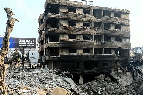 A destroyed building sits near a crater at the site of an overnight Israeli airstrikes that targeted Beirut's southern suburb on October 10, 2024.