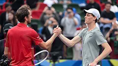 Italy’s Jannik Sinner (R) shakes hands after winning against Russia's Daniil Medvedev during their men's singles match at the Shanghai Masters.