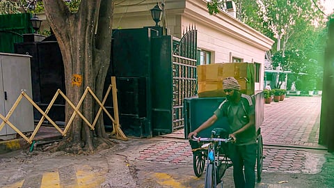 A worker carrying goods on a cart leaves from 6, Flagstaff Road in Civil Lines, the official residence of Chief Minister of Delhi, in New Delhi, Wednesday, Oct. 9, 2024.