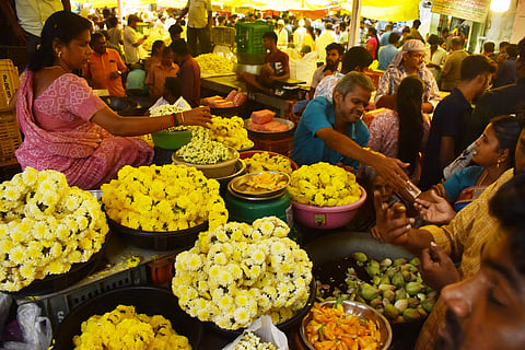 People engaged in shopping for pooja materials at the flower market on the occasion of the Ayudha Pooja festival in Chennai