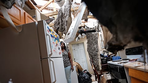 Natasha Ducre surveys the kitchen of her devastated home, which lost most of its roof during the passage of Hurricane Milton, in Palmetto, Fla., Thursday, Oct. 10, 2024.