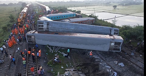 Drone shot of Indian railway workers restoring the site by pushing the coaches of the Mysuru-Darbhanga Bagmati Express train at the Kavaraipettai Railway Station.