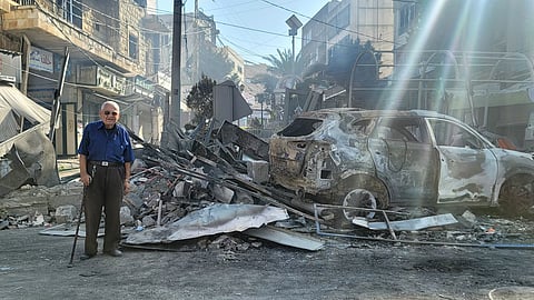 A man walks past the rubble of a shop a day after an Israeli airstrike targeted the marketplace of the southern Lebanese city of Nabatiyeh on October 13, 2024, amid the continuing war between Hezbollah and Israel.
