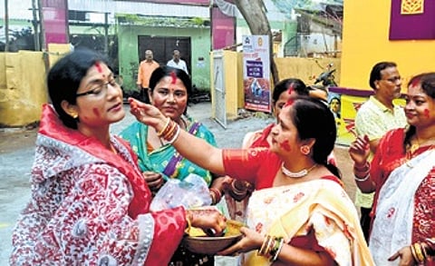 Bengali women applying vermilion on each other at Sahid Padia in Baripada.