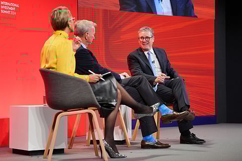 ) CEO of the British multinational pharmaceutical and biotechnology company GSK Emma Walmsley, CEO of US multinational corporation and technology company Google Eric Schmdit and Britain's Prime Minister Keir Starmer speak on stage.