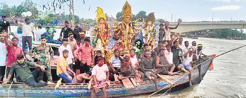 Idols being taken in boats before immersion in Hansua River on Monday.