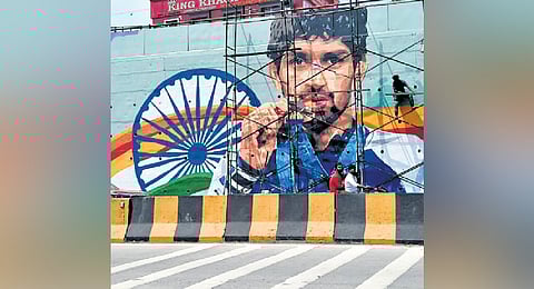 Workers apply finishing touches to a large mural of freestyle wrestler Aman Sehrawat with his Olympic medal in Hyderabad. The 21-year-old from Haryana became the youngest Indian to win an individual Olympic medal, having secured a bronze at the 2024 Paris Olympics