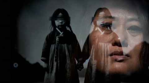 Rebecca Kimmel is seen reflected in her artwork depicting twins at her home Saturday, Feb. 3, 2024, in Seattle.