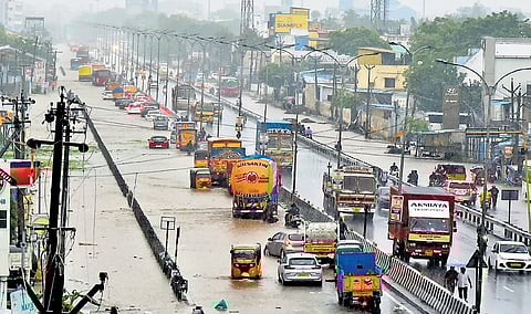 Vehicles wading through a flooded road in Red Hills