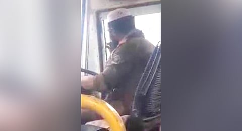A snapshot of a KSRTC bus driver smoking a beedi while driving the bus
