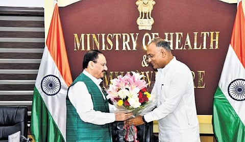 Health Minister Dinesh Gundu Rao greets Union Health Minister JP Nadda in New Delhi on Wednesday