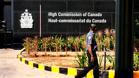 A private security man walks outside the Canadian high commission in New Delhi, India, Tuesday, Oct. 15, 2024 after India and Canada expelled each other’s top diplomats over an ongoing dispute about the killing of a Sikh activist in Canada.