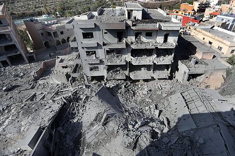 Destroyed buildings that were hit by Israeli airstrikes are seen in Qana village, south Lebanon, Wednesday, Oct. 16, 2024.